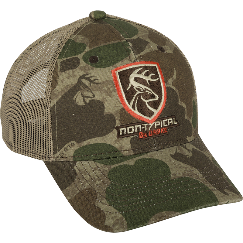 A camouflage hat with the Non-Typical logo on the front, made of 100% cotton twill and breathable mesh on the back. Features a rear hook and loop closure.