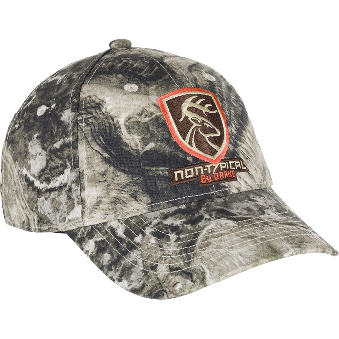 Non-Typical Logo Camo Cotton Cap - Mossy Oak Terra Coyote: A camouflage hat with a logo on it, made of 100% cotton twill fabric. Features a six-panel construction, mid-profile fit, and hook & loop closure. One size fits most.