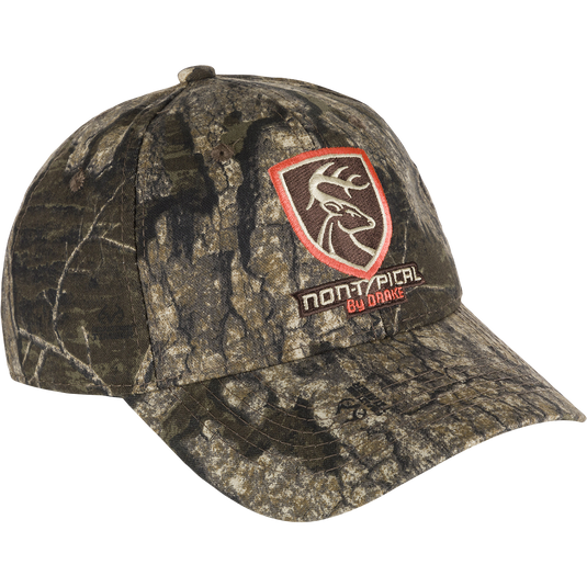 Non-Typical Logo Cotton Camo Cap with deer head patch and logo close-up. Adjustable hook & loop closure. High-quality hunting gear.