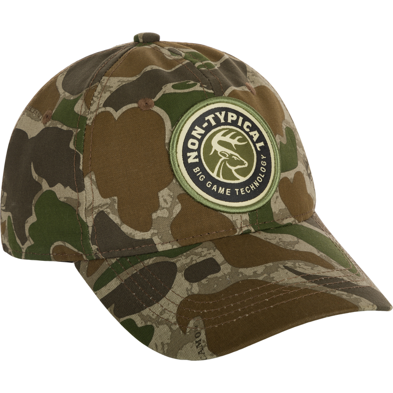 A close-up of the Big Game Technology Patch Camo Twill Cap, featuring a camouflage hat with a logo patch.