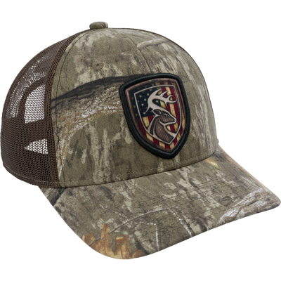 Americana Shield Patch Mesh-Back Cap with a deer head and stars and stripes patch, featuring a 100% cotton twill front and snap closure mesh back.