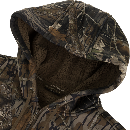 A close-up of the Nontypical Non-Typical Slacker Quarter Zip Hoodie shows a camouflage hood, soft polyester microfiber, drawstrings, and detailed stitching in brown, green, and tan.