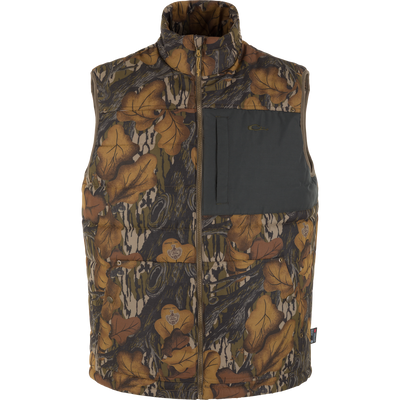Delta Featherless Down Vest in woodland camouflage, featuring a high collar, front zipper, and Magnattach™ chest pocket, ideal for lightweight warmth and outdoor layering.