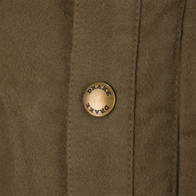 Close-up of Delta Moleskin Shirt Jacket's suede-like fabric with a vertical stitched seam and embossed brass snap-button labeled “DRAKE,” highlighting rugged, high-quality outdoor wear.