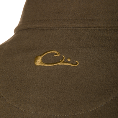 Close-up of Delta Moleskin Shirt Jacket's brown suede hat seam, showcasing textured fabric, stitching, and gold embroidery detail, highlighting craftsmanship and durability for outdoor use.