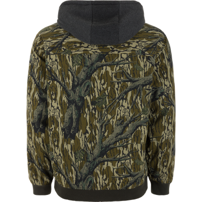 Back view of the Campfire Canvas Bomber Jacket by Lifestyle, featuring a green and brown camo pattern with tree branches and leaves, plus dark ribbed cuffs and hem.