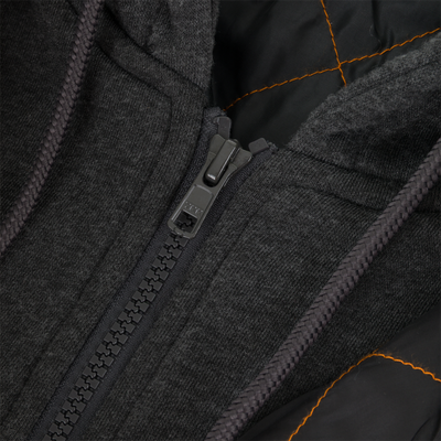 Close-up of the Campfire Canvas Bomber Jacket by Lifestyle: black with a plastic zipper, orange-lined interior, and textured fabric around the zipper and hood for rugged workwear durability.