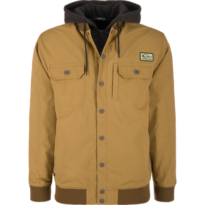 The Lifestyle Campfire Canvas Bomber Jacket in Field Khaki features a black hood with adjustable drawstrings, front snap buttons, two chest pockets, ribbed cuffs and hem, and a signature logo patch.