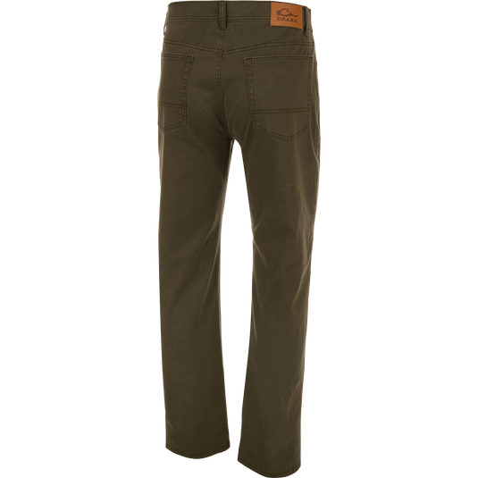 Back view of olive green Wingshooter Twill 5 Pocket Pant with a leather logo patch on the back waistband.