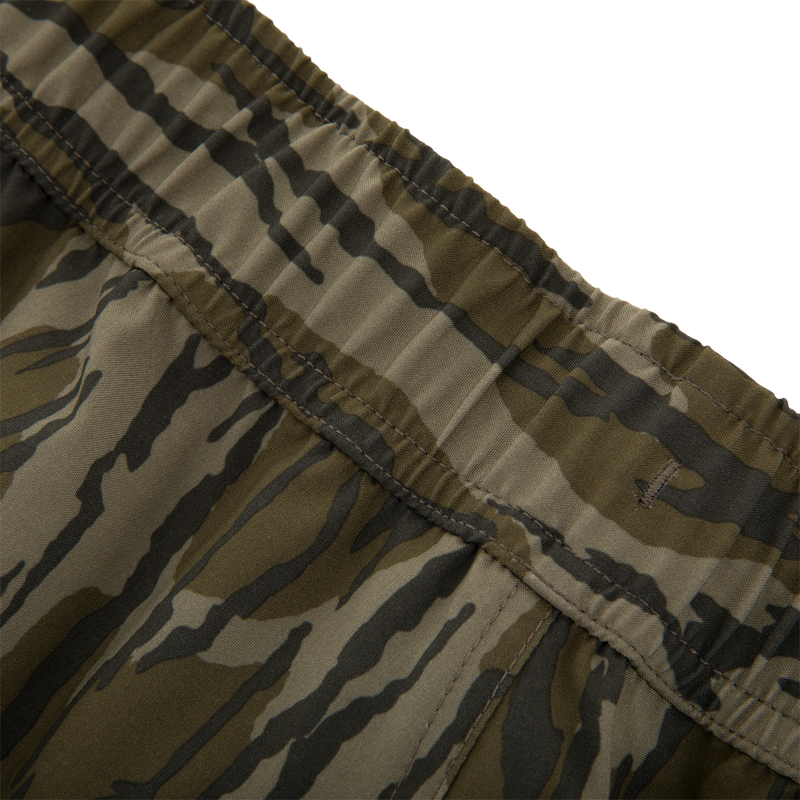 Close-up of Lake Shore Shorty Short's elastic waistband showcasing tiger-stripe camo print, highlighting stitching and fabric texture designed for water activities with style and comfort.