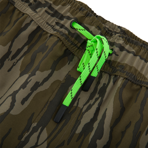 Close-up of Drake Lake Shore Shorty Short, featuring a camouflage pattern, elastic waistband, neon-green drawstring, and mesh-lined pockets, designed for water activities.