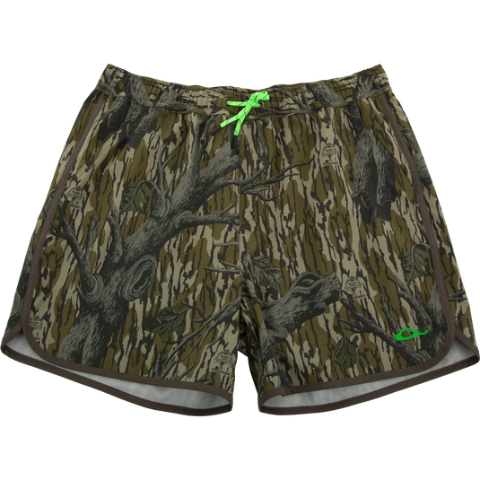 Lake Shore Shorty Short with Mossy Oak camo print, elastic waistband, bright green drawcord, side pockets, and contrasting hem trim, ideal for water activities.