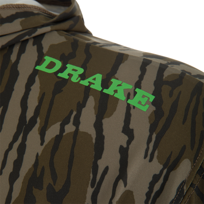 Close-up of Lake Shore Performance Long Sleeve Hoodie, featuring camouflage print with DRAKE in green, showcasing lightweight, moisture-wicking fabric ideal for outdoor activities.