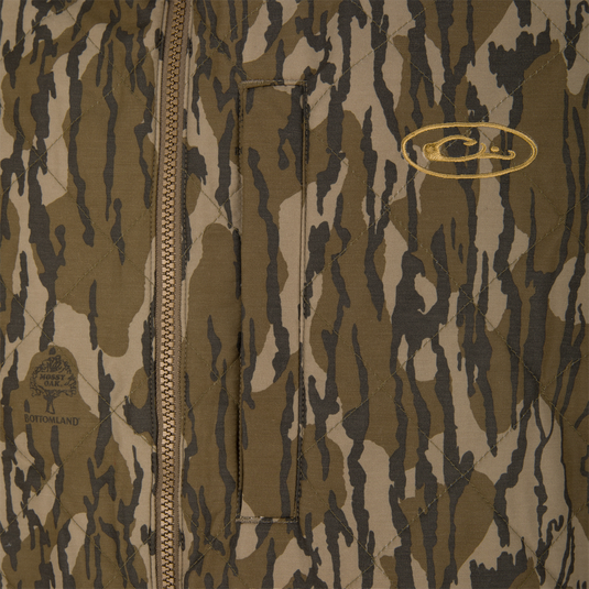 Delta Quilted Vest in a brown and tan camouflage pattern, featuring a quilted, water-resistant design with a front zipper and embroidered Lifestyle logos on the chest.