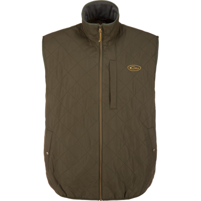 Lifestyle Delta Quilted Vest in Forest Night: a dark olive quilted vest with a full-length front zipper, a stand-up collar, and a small logo embroidered on the left chest, designed as a versatile outdoor performance vest.