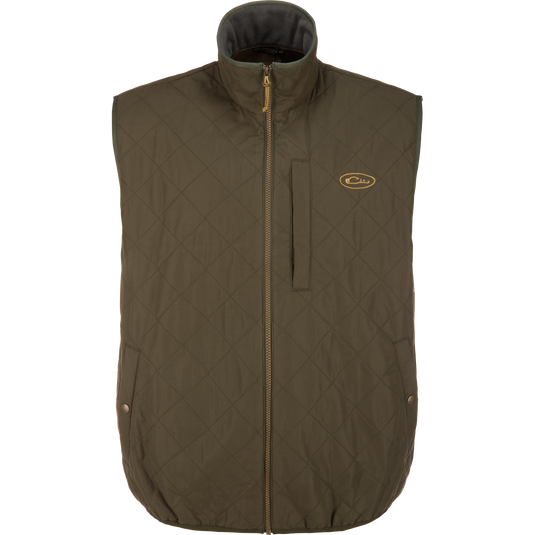 Lifestyle Delta Quilted Vest in Forest Night: a dark olive quilted vest with a full-length front zipper, a stand-up collar, and a small logo embroidered on the left chest, designed as a versatile outdoor performance vest.