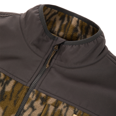 Camp Fleece Over Under Quarter Zip durable outdoor pullover featuring a solid dark shoulder panel and a brown and black animal print pattern on the body.