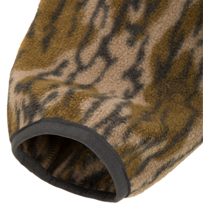 Close-up of a brown and black camouflage Camp Fleece Over Under Quarter Zip sleeve cuff with dark grey trim.
