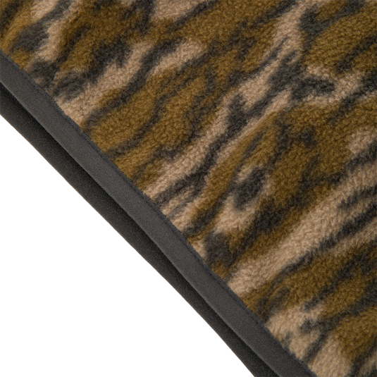 Close-up of the brown and black tiger stripe pattern on the fuzzy Camp Fleece Over Under Quarter Zip, featuring a charcoal-colored edge binding.