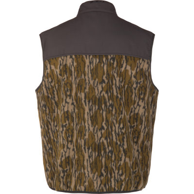 Camp Fleece Vest features a dark yoke with woodland camouflage print, offering comfort and durability with water-resistant overlay and Magnattach™ pocket for outdoor use.