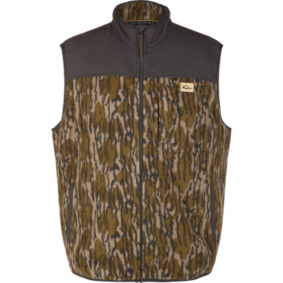 Camp Fleece Vest featuring camouflage fleece, solid dark shoulders, full zipper, and branded chest patch; offers warmth, water resistance, and practical pockets for outdoor activities.