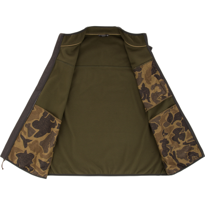 Camp Fleece Vest interior features soft lining, camo-patterned pockets, and Drake label, highlighting its warmth, durability, and practical design for versatile outdoor use.