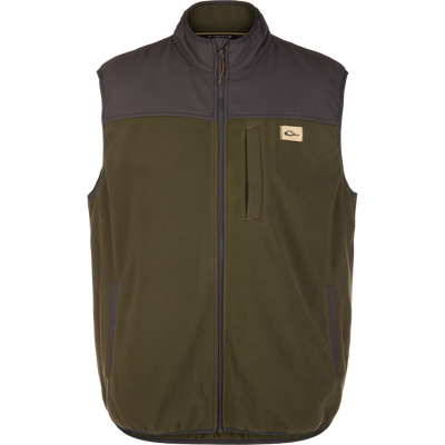 Camp Fleece Vest with olive fleece body, dark gray soft-shell yoke, stand-up collar, full zipper, and branded chest patch. Features weather-resistant materials and practical pockets.