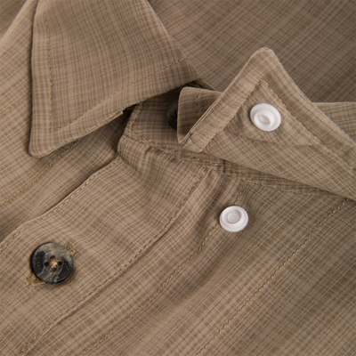 Close-up of Wingshooter Cross Hatch Shirt's woven fabric, showing folded collar, button placket, and textured weave, highlighting its lightweight, breathable design for outdoor comfort.