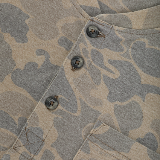 Close-up of a tan and gray camouflage Tri-Blend Henley Over Under featuring a three-button placket and a chest pocket.
