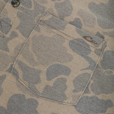 Close-up of a Tri-Blend Henley Over Under in a tan and gray camouflage pattern, featuring a single chest pocket and a visible button at the collar.