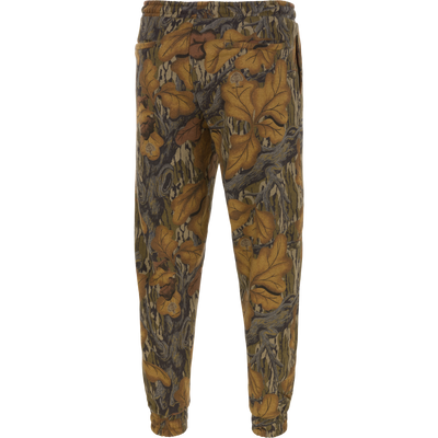 Back view of Three End Cargo Sweat Pant in a brown, tan, and gray leaf camouflage pattern with a drawstring waist and cuffed ankles.