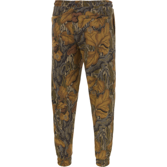 Back view of Three End Cargo Sweat Pant in a brown, tan, and gray leaf camouflage pattern with a drawstring waist and cuffed ankles.