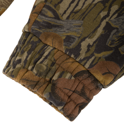 Close-up of a brown and green camouflage Three End Cargo Sweat Pant leg with a gathered elastic cuff.