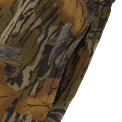 Close-up of Lifestyle Three End Cargo Sweat Pant in a leaf and bark camouflage pattern, featuring a side pocket and stretch technology.