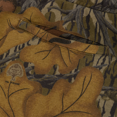 Close-up of Three End Cargo Sweat Pant in midweight camouflage, featuring a welt pocket and a printed logo of a tree above the text Fall Foliage.