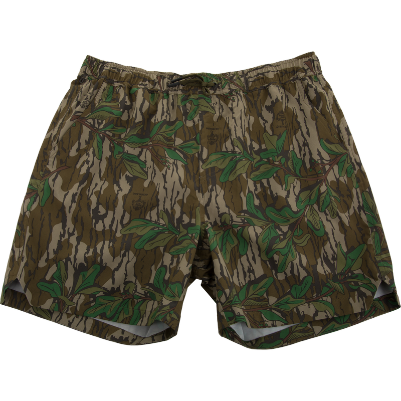 Lake Shore Dock Short featuring a camouflage pattern with green leaves, elastic waistband, drawstring, mesh-lined pockets, and zippered side pocket, ideal for water activities.