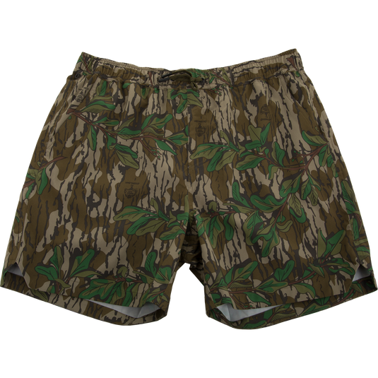 Lake Shore Dock Short featuring a camouflage pattern with green leaves, elastic waistband, drawstring, mesh-lined pockets, and zippered side pocket, ideal for water activities.
