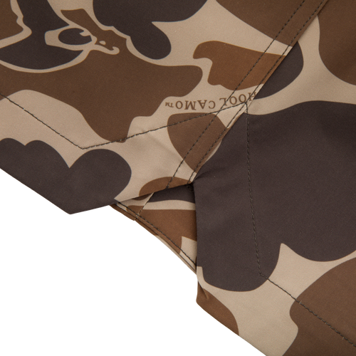 Close-up of Americana Lake Shore Dock Short's camouflage fabric, showcasing detailed stitching and CAMO™ print, highlighting its durable, water-repellent design suited for outdoor activities.