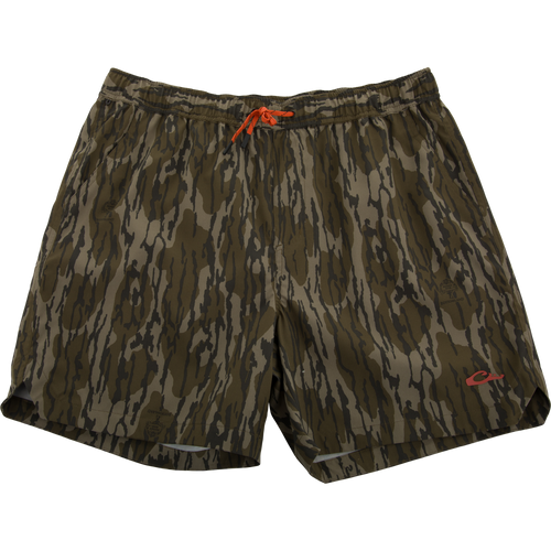 Lake Shore Dock Short with twig camouflage print, bright orange drawcord, and logo. Features elastic waistband, mesh-lined pockets, and zippered side pocket for outdoor activities.