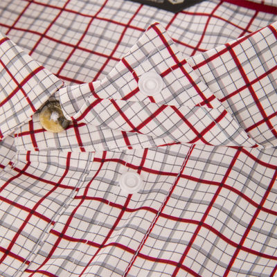 Wingshooter Trey Shirt close-up showing plaid pattern, folded collar, buttons, highlighting breathable, quick-drying fabric with UPF protection, ideal for versatile outdoor wear.