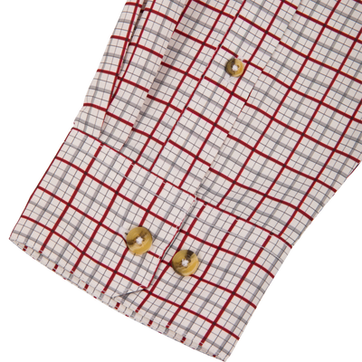 Wingshooter Trey Shirt sleeve close-up showcasing red-and-gray plaid pattern with horn-tone buttons, highlighting its lightweight, breathable design for versatile outdoor use.