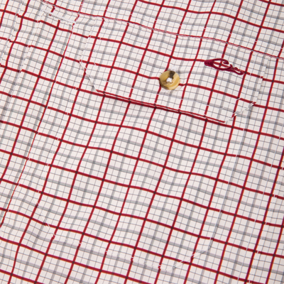 Close-up of Wingshooter Trey Shirt fabric showing check pattern, chest pocket flap with button, and red embroidery, highlighting its lightweight, breathable polyester design for outdoor comfort.