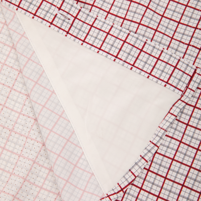 Close-up of the Wingshooter Trey Shirt's check-patterned placket, showing a stitched buttonhole and the plain white underside, highlighting its lightweight comfort and performance features.