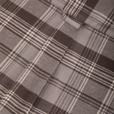 Close-up of the Drake Autumn Flannel Shirt, showcasing its plaid pattern in tan, gray, and brown, highlighting the stitched seam and fabric loop, perfect for outdoor activities.
