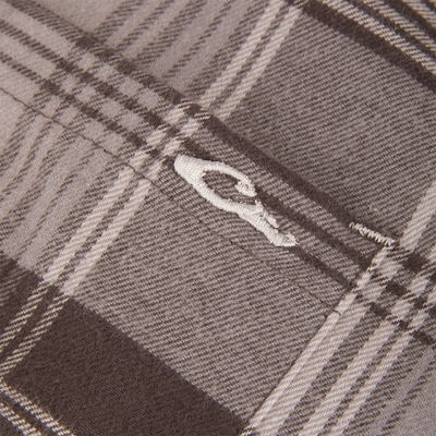 Macro shot of beige-and-brown tartan fabric with embroidered seam, representing the Drake Men's Autumn Flannel Shirt, designed for comfort and flexibility in outdoor activities.