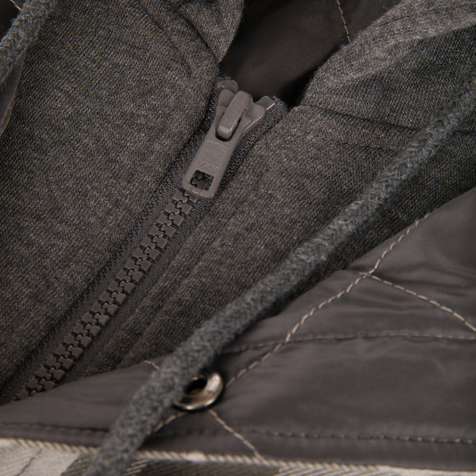 Close-up of The Campfire Flannel Hoodie showing the zipper, drawstring, and insulated quilted panels.