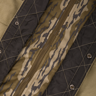 Close-up of The Youth Campfire Flannel Hoodie's heavy nylon zipper on camouflage fabric, featuring black quilted lining with snap-button closures, highlighting rugged durability.