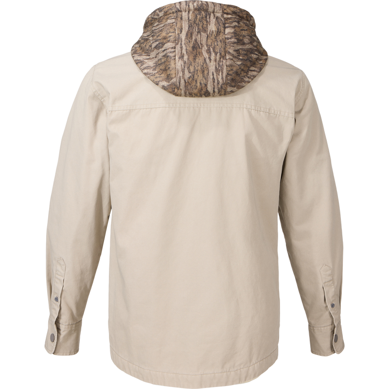 Back view of the Campfire Canvas Shirt Jac Hoodie, featuring a camouflage hood, button-adjustable cuffs, and designed for warmth in outdoor activities.