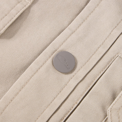 Close-up of Campfire Canvas Shirt Jac Hoodie, showcasing beige canvas fabric, stitched seams, and embossed snap-button detail, emphasizing its durable, workwear-inspired design.