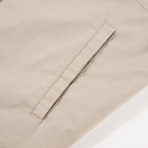 Close-up of the Drake Campfire Canvas Shirt Jac Hoodie, highlighting a single welt pocket with neat stitching, exemplifying durable design for versatile, stylish warmth.